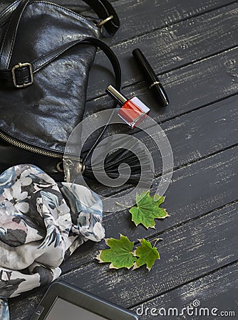 Women accessories black leather handbag, scarf, watch, nail Polish and tablet computer Stock Photo
