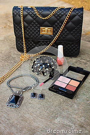 Women accessories: eyeshadow, nail polish, clip hair, handbag Stock Photo