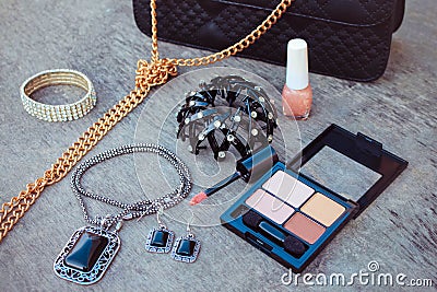 Women accessories: eyeshadow, nail polish, clip hair, handbag Stock Photo