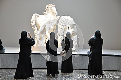 Women admiring antique Greek artworks in Louvre Abu Dhabi Editorial Stock Photo