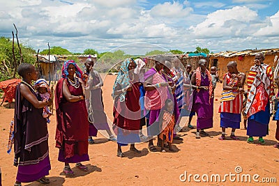 women from the African tribe Maasai in national dress in their village houses made of clay Editorial Stock Photo