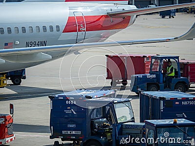 Women airport maintenance worker loading and repairing plane Editorial Stock Photo