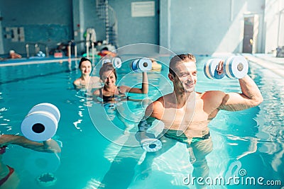 Women aqua aerobics traninig with dumbbells Stock Photo