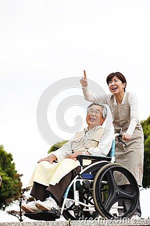 Women assisted wheelchair Stock Photo