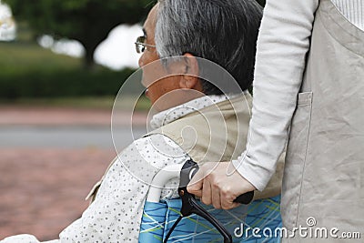 Women assisted wheelchair Stock Photo