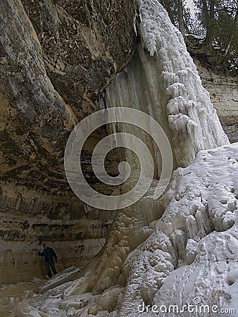 Women behind frozen waterfall Stock Photo