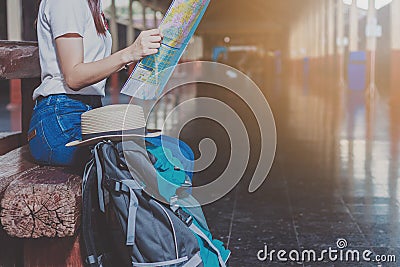 Women, blue backpack and hat at the train station Stock Photo