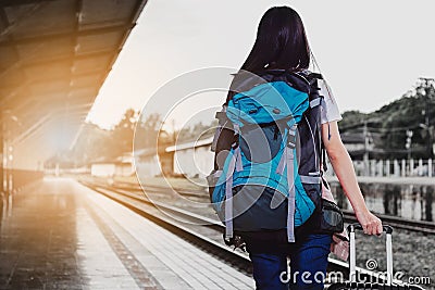 Women, blue backpack and hat at the train station Editorial Stock Photo