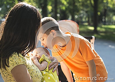 Women, brother and baby in a park. Stock Photo