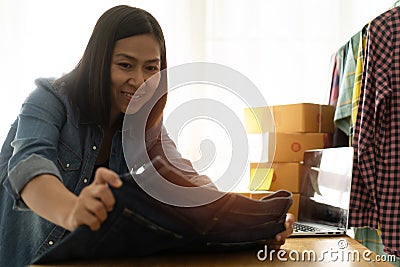 Women business owner work at home with pants jeans Stock Photo