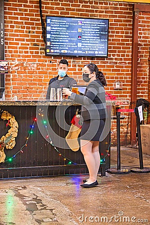 Women buy drinks at the Bar in San Pedro Square Market in San Jose Editorial Stock Photo