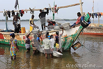 Women buy fish in Ada Foah, Ghana. Editorial Stock Photo