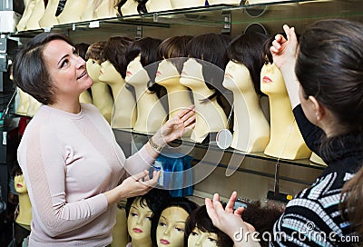 Women buying modern periwigs Stock Photo