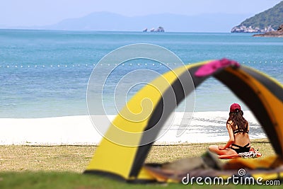 Teen girl in bikini camping and relaxing,Tent on the beach Editorial Stock Photo