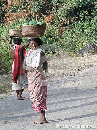 Women carry goods on their Editorial Stock Photo