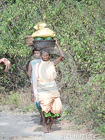 Women carry goods on their head Editorial Stock Photo