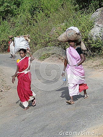 Women carry goods on their heads Editorial Stock Photo