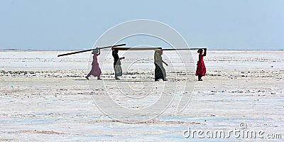 Women carrying plywood in the desert Editorial Stock Photo