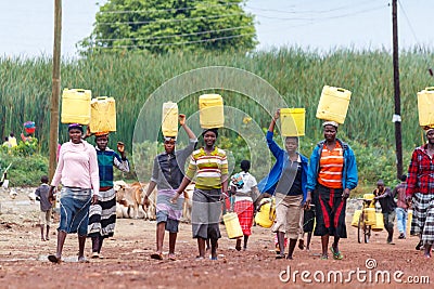 Women carrying water Editorial Stock Photo