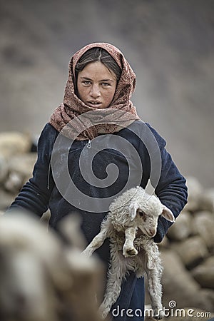 Women and children wake up in the morning to milk sheep, goats and yaks in very heavy snow conditions and very low temperatures at Editorial Stock Photo