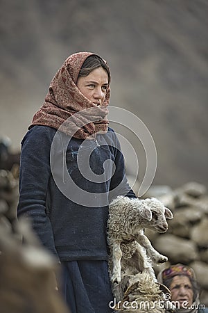 Women and children wake up in the morning to milk sheep, goats and yaks in very heavy snow conditions and very low temperatures at Editorial Stock Photo