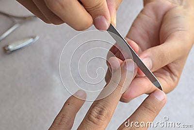 Women clean the fingernail for the customer with a nail file Stock Photo