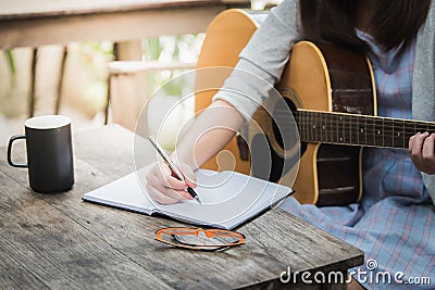 Women compose song and play guitar Stock Photo