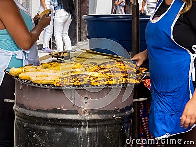 Women cooking and selling roasted ripe plantain at Cali city center Editorial Stock Photo