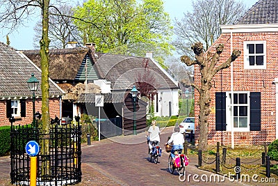 Women are cycling in the ancient Kerkebuurt (Church district) in Soest, Netherlands Editorial Stock Photo