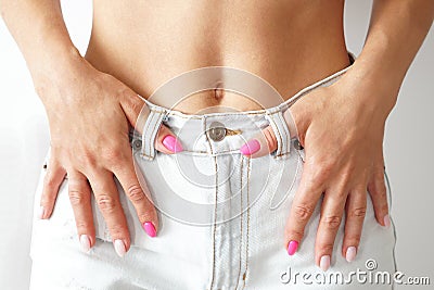 Women in denim . Trendy manicure. Beautiful belly Stock Photo