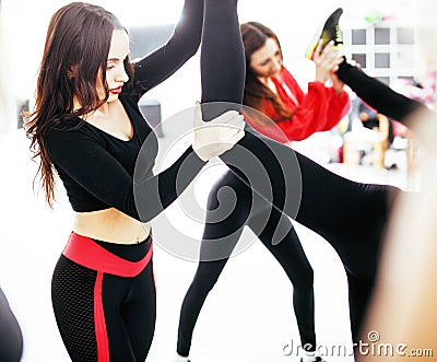 Women doing sport in gym, healthcare lifestyle happy people concept, modern loft studio, flying in jump Stock Photo