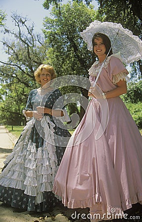 Women dressed in period piece costumes of the Old South, Charleston, SC Editorial Stock Photo