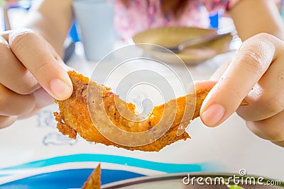 Women eating chicken wings in Thai restaurant. Stock Photo