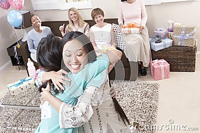 Women Embracing At Baby Shower Stock Photo