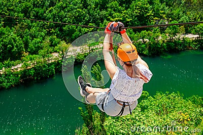 Women Enjoying Thrilling Zipline Experience, Embracing the Exhilaration of Activity-filled Vacation Stock Photo