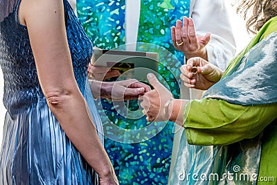 Women exchanging wedding vows Stock Photo