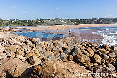 Women Exploring Beach Tidal Pool Stock Photo