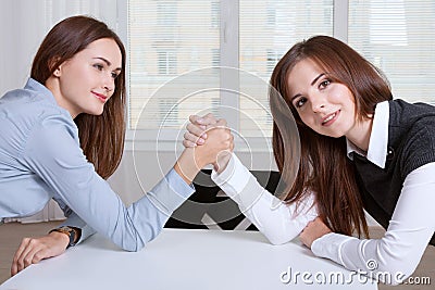 Women finance competitive worker while armwrestling Stock Photo