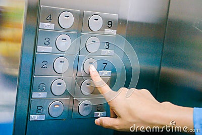 Women finger press number floor in the elevator Stock Photo