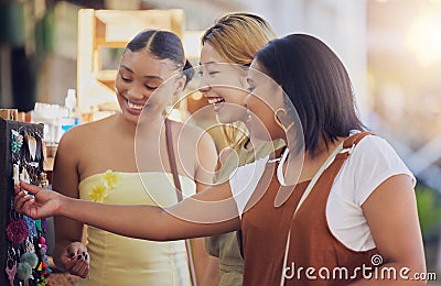 Women, friends and shopping at outdoor market, happy with discount and sale with cosmetic jewellery. Diversity Stock Photo