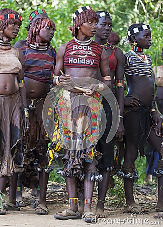 Women get ready for dancing at bull jumping ceremony. Turmi, Omo Valley, Ethiopia. Editorial Stock Photo