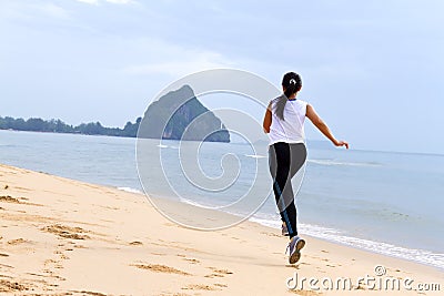 Women good shape morning running on beach Stock Photo