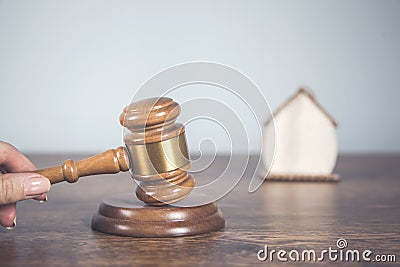 Women hand judge with house model Stock Photo