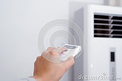 Women hand is regulating the heater/air condition temperature Stock Photo