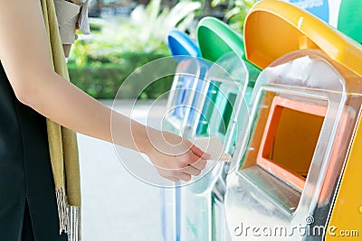 Women hand throwing away the garbage to the bin/trash, sorting waste/garbage before drop to the bin Stock Photo