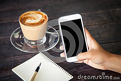 Women hand using smartphone,cellphone,tablet over wooden table Stock Photo