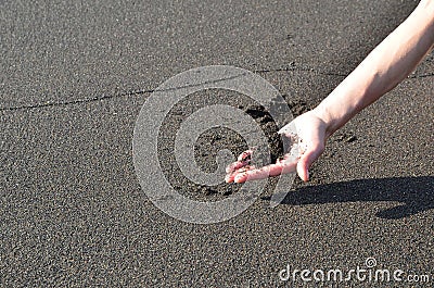 women hand on vulcano beach Stock Photo