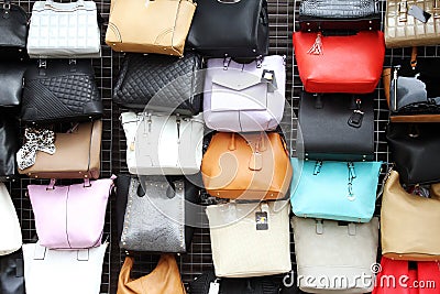 women handbags hanging on wall in market Stock Photo