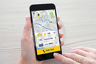 Women hands holding phone with application call taxi on screen Stock Photo