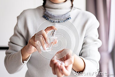 Woman hands spraying favorite perfume at home,Applying perfume is the simplest of matters Stock Photo